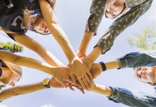Female Teen Friends Stacking Hands Together